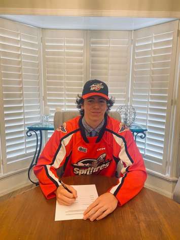 A.J. Spellacy signs his OHL Standard Player Agreement with the Windsor Spitfires, June 22, 2022. Photo courtesy Windsor Spitfires.