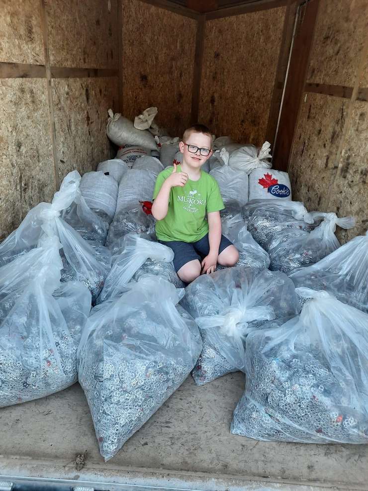 Jace Weber celebrates a world record for collecting the most pop tabs in a year. Photo by Candice Weber