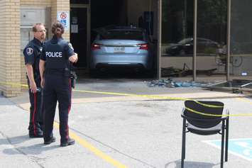 Three people were sent to hospital after a car smashes through the front of an RBC Bank on Huron Church Rd., July 3, 2015. (Photo by Jason Viau)