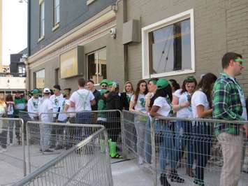 A group of St. Patrick's Day revellers lined up outside of The Ceeps on Richmond Row, March 17, 2017. (Photo by Miranda Chant, Blackburn News.)