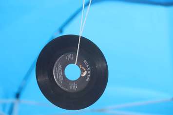 An old 45 hangs from the roof of the Dr Disc tent at the 2018 Buskerville Festival. (Photo by Adelle Loiselle)