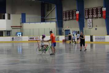 Learning how to ride a bike with the help of volunteers at the iCan Bike Camp in Chatham. July 13, 2016. (Photo by Natalia Vega)