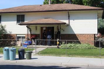 Windsor police officers investigate the 900-block of Pillette Rd. where a gunman was arrested, June 1, 2016. (Photo by Jason Viau)