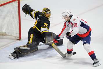 Sarnia Sting goaltender Ben Gaudreau makes a pad save against Windsor's Wyatt Johnston.  1 May 2022.  Metcalfe Photography)