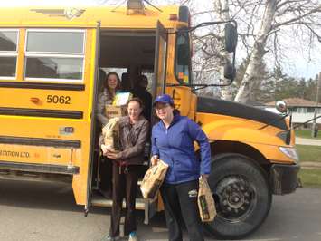 Wingham Sacred Heart Students load donated food into school bus for 'Stuff That Bus ' event. (BlackburnNews.com file photo)