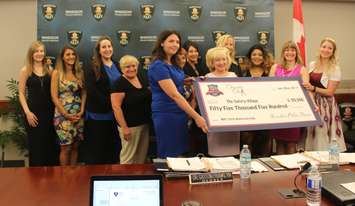 Charity Chix and Windsor police service present checks to charities, June 22, 2017. (Photo by Maureen Revait) 