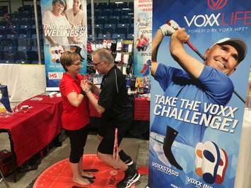 Retired nurse Sharon Caines (left) demonstrates Voxx Life products with Jim Canie