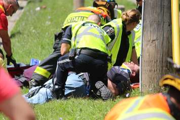 EMS Crews tend to a number of people after a crash between a car and minivan at St. Luke Rd. and Richmond St., July 31, 2015. (Photo by Mike Vlasveld)