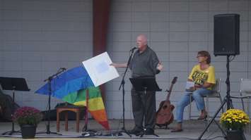 Dave Moore speaks on the story of the kite and the Kite Banner art piece. World Suicide Prevention Day at Canatara bandshell, September 10, 2015 (BlackburnNews.com Photo by Briana Carnegie)