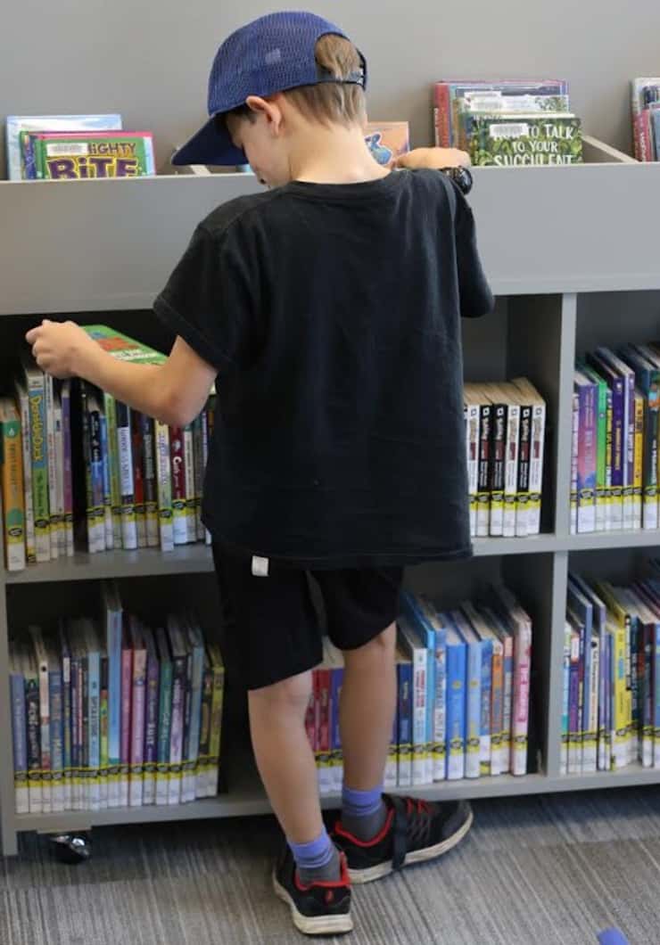 A child browsing books at the Watford Library (Photo courtesy of County of Lambton)
