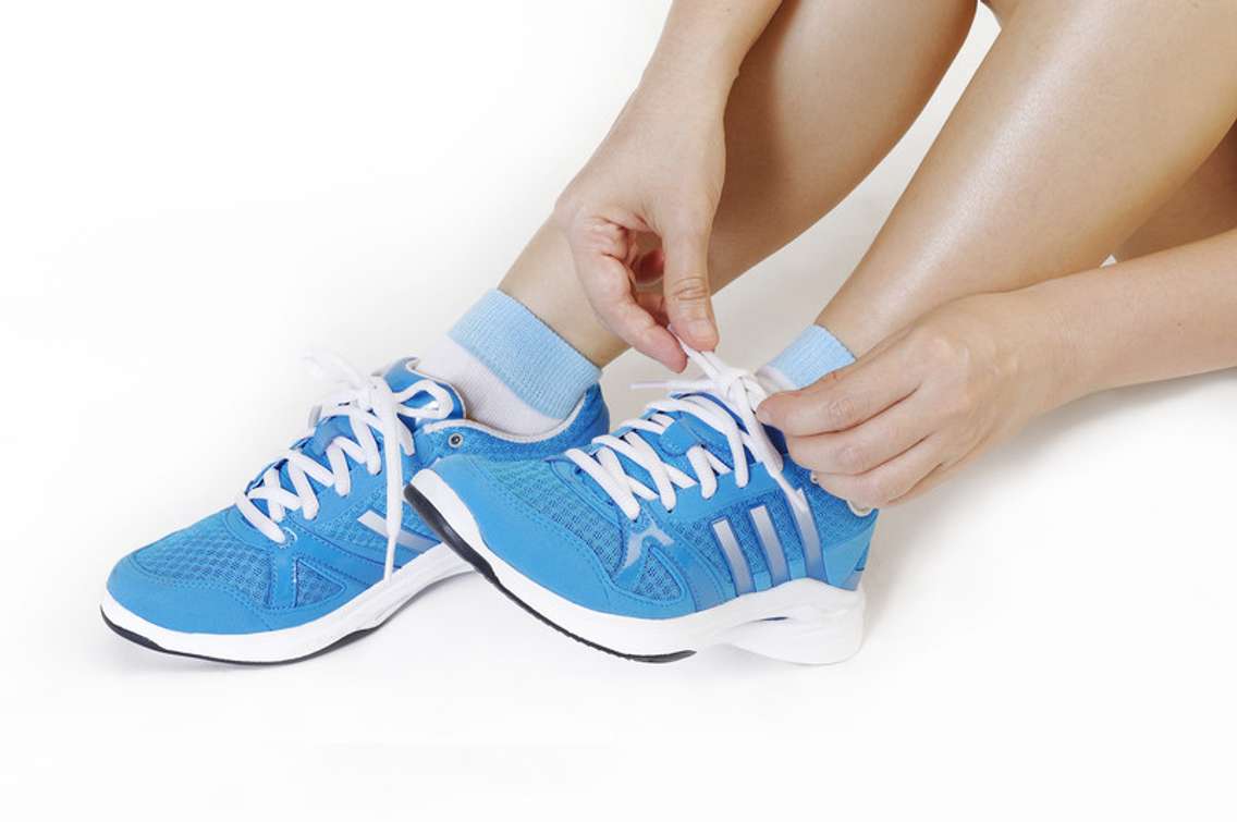 Girl tying running shoes. © Can Stock Photo Inc. / phloen