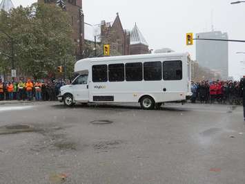 A bus carrying veterans from the Parkwood Institute is cheered by the crowd at the Remembrance Day ceremony  in Victoria Park, November 11, 2019. (Photo by Miranda Chant, Blackburn News)