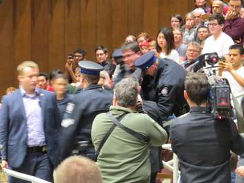 A man is forcibly removed from the Prime Minister's town hall meeting in London, January 11, 2018. (Photo by Miranda Chant, Blackburn News)