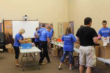 Volunteers filling backpacks with school supplies for local children going back to school. August 29, 2016. (Photo by Natalia Vega)