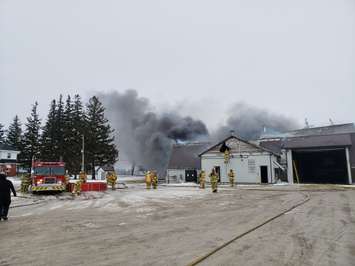 Perth East firefighters battle a large structure fire south of Milverton. Photo courtesy of the OPP.