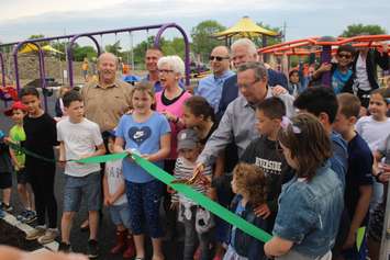 A ceremonial ribbon is cut with students from St. Rose Catholic School at Farrow Riverside Miracle Park in Windsor, May 24, 2019. Photo by Mark Brown/Blackburn News.