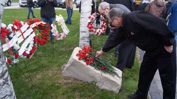 Red flowers were laid at Sarnia's Firefighters' Memorial Garden on East St. Thursday for the National Day of Mourning. April 28, 2016 (BlackburnNews.com Photo by Briana Carnegie)