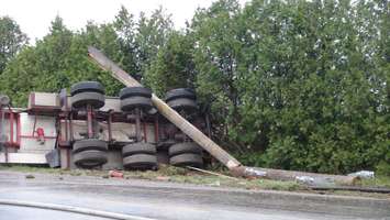 The transport truck took out a hydro pole in the process, breaking it in two pieces.