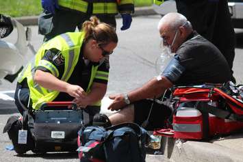 EMS crews tend to a number of people after a crash between a car and minivan at St. Luke Rd. and Richmond St., July 31, 2015. (Photo by Mike Vlasveld)