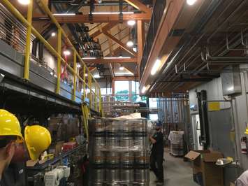 The cellar area of Cowbell, with a full auto-canning machine, mill area, and beer storage tanks. August 3rd, 2017 (Photo by Ryan Drury)
