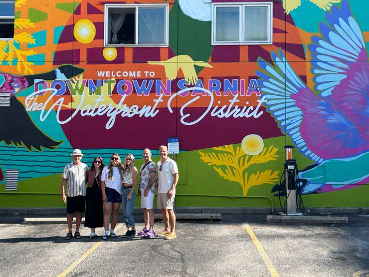 Patrick Coutu and the artists in front of a new mural downtown Sarnia (Photo by: Lindsay Newman/ Blackburn Media)