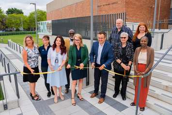 Windsor-Tecumseh MP Irek Kusmierczyk, third from right in sport jacket, helps cut the ribbon for the new accessible entrance to the Human Kinetics Building at the University of Windsor, July 15, 2024. Photo courtesy University of Windsor.