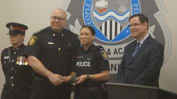 Sarnia Police Chief Derek Davis (left) and Police Board Chair Paul Wiersma (right) pose for picture with new police constable Danielle Johnson. 6 April 2023. (Photo by SarniaNewsToday.ca)