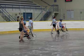 Learning how to ride a bike with the help of volunteers at the iCan Bike Camp in Chatham. July 13, 2016. (Photo by Natalia Vega)