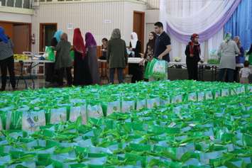 Members of the Windsor and Essex County Muslim community pack 1,500 bags full of food and toiletries for the ninth annual Spirit of Ramadan Food Drive, July 21, 2015. (Photo by Mike Vlasveld)