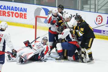 A scrum between Sarnia Sting and Windsor Spitfires.  26 April 2022. (Metcalfe Photography)