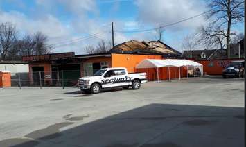 A security truck sits outside the charred remains of Hogtown Cycles in Lucan. Photo by Jake McKenzie. 