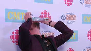 Curtis Rempel of High Valley kisses the duo of the year award at the CCMA Awards in London, September 11, 2016. (Photo by Miranda Chant, Blackburn News)