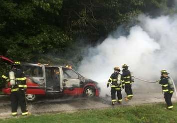 A mini-van burns on Mersea Rd. 15. September 4, 2015 (Photo by Leamington Fire)