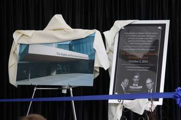 A plaque is unveiled at UWindsor's new Stephen and Vicki Adams Welcome Centre, October 2, 2015. (Photo by Mike Vlasveld)