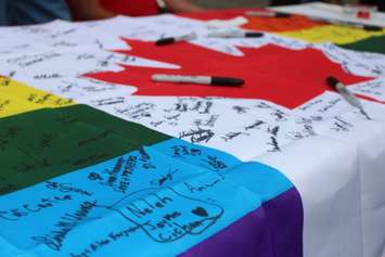 A Canadian Pride flag is signed and to be delivered to Orlando as part of a vigil held in Windsor on June 15 after a deadly shooting at a gay nightclub in Orlando. (Photo by Ricardo Veneza)