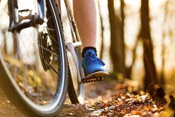 A person cycling along a trail. File photo courtesy of © Can Stock Photo / halfpoint