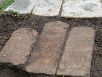Confederation-era tombstones uncovered by Western students at Woodland Cemetery. (Photo by Miranda Chant, Blackburn News)