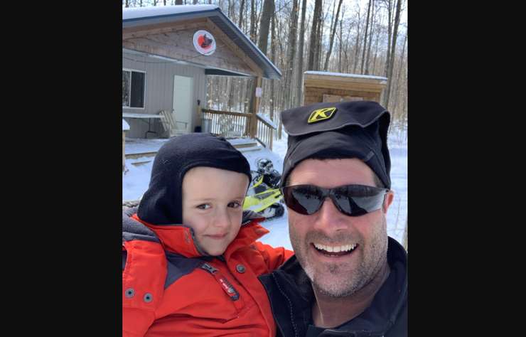 (Left to right) Chase and Derek Clark pose for a selfie in front of one of the Warwick Snowmobile Club's warming stations. Submitted photo. 