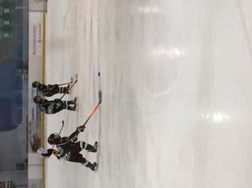 A Twin-Centre Novice player controls the puck during their game against Mitchell. (Photo by Marty Thompson)
