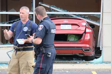 Emergency crews respond to a walk-in clinic on Tecumseh Rd. E after a car smashes through the front window, June 8, 2015. (Photo by Jason Viau)