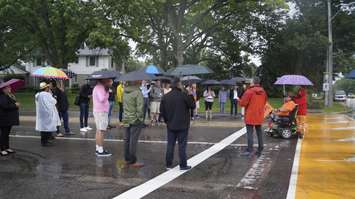 Gathering at Cathcart Boulevard and Christina Street North for the dedication ceremony. June 20, 2022. (Photo by Natalia Vega)