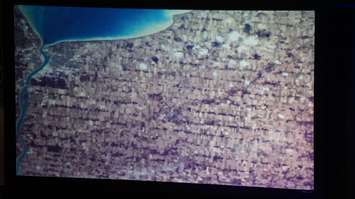 Chris Hadfield shows photo  from space of Sarnia-Lambton during keynote address in Sarnia. May 25, 2016 (BlackburnNews.com Photo by Briana Carnegie)