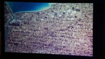 Chris Hadfield shows photo  from space of Sarnia-Lambton during keynote address in Sarnia. May 25, 2016 (BlackburnNews.com Photo by Briana Carnegie)