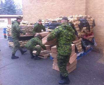 Members of the Essex and Kent Scottish Regiment help load Chatham Goodfellows food baskets ahead of their delivery. (Photo by Mike James)