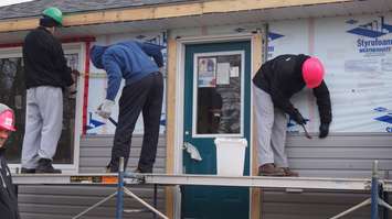 The Sarnia Sting helps with construction of Habitat for Humanity's latest build. December 2, 2014 (BlackburnNews.com photo by Jake Jeffrey)
