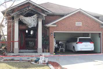 Fire investigators comb through a house on Spago Cres. after a weekend blaze, March 30, 2015. (Photo by Jason Viau)