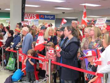 A crowd of supporters await the arrival of Tessa Virtue and Scott Moir at the London International Airport. February 26, 2018. Photo by Scott Kitching