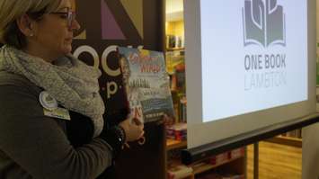 Book Keeper Owner Susan Chamberlain holds up a copy of 