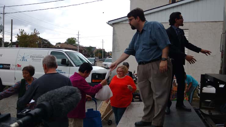 Downtown Mission executive director Ron Dunn hands out turkeys during a giveaway on October 4, 2017. Photo by Mark Brown/Blackburn News.