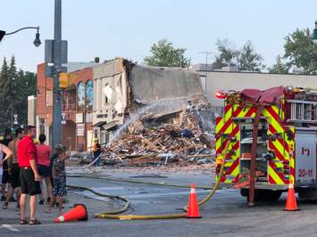 An explosion in downtown Wheatley brings a building down to rubble and severely damages surrounding structures. (Photo credit: Kathryn Parent, Photography by Phos³ via Twitter)